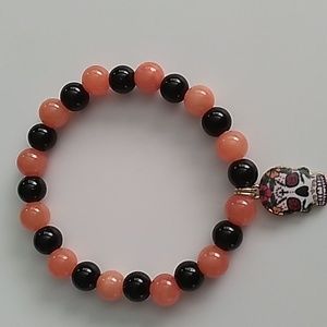 Orange and Black stretch bracelet with Halloween mask charm